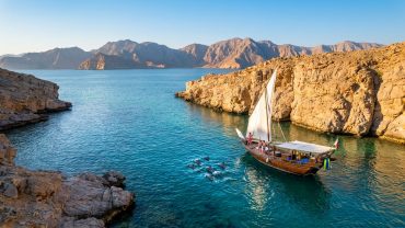Musandam Oman coastline with dramatic fjords, mountains, and clear blue waters near Khasab