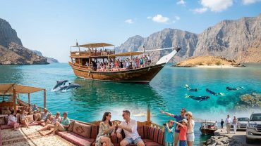 Traditional dhow cruise on Musandam fjords during a Khasab tour package experience in Oman